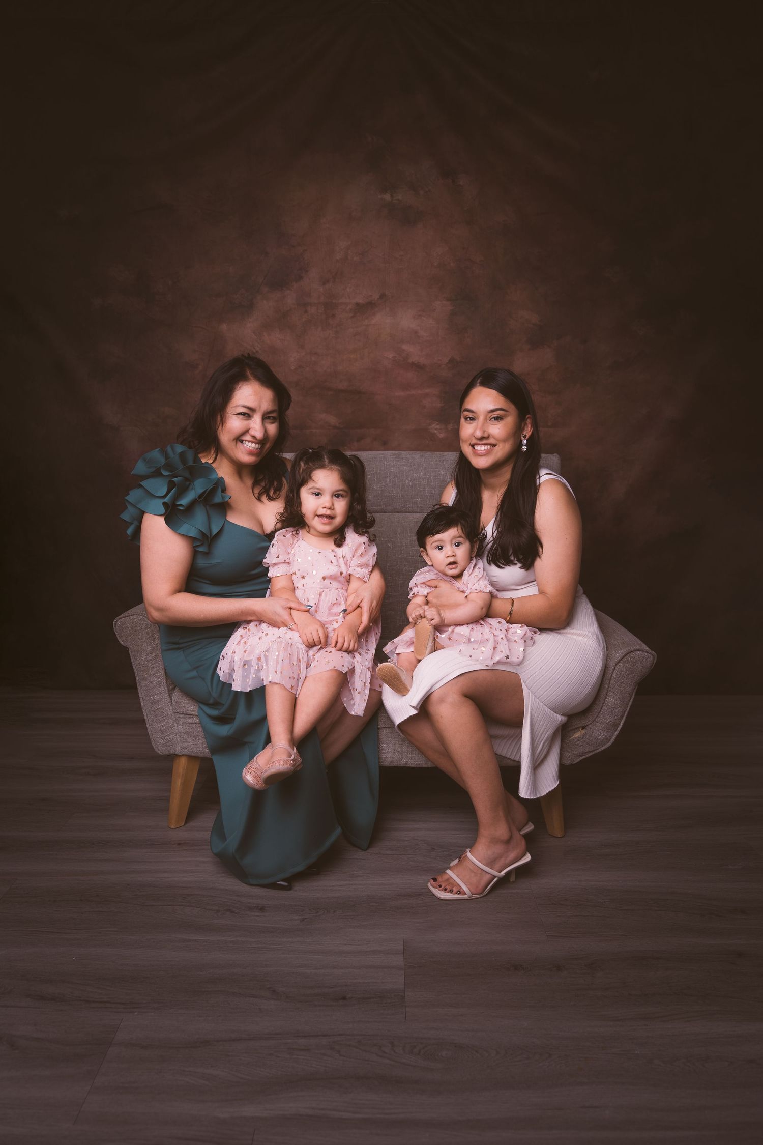 Family photoshoot showing playful poses and interactions against a dark backdrop.