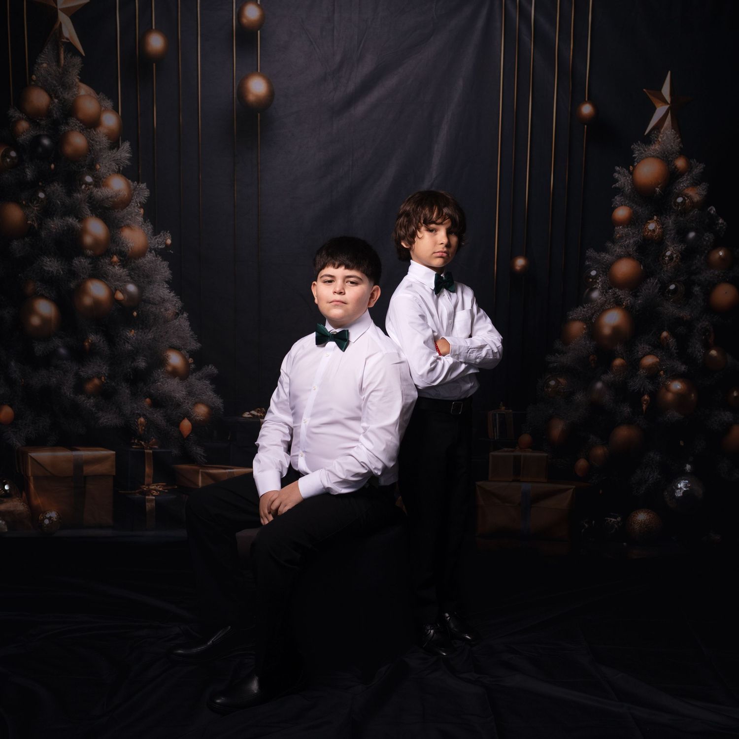 Studio photography session with formal attire against dark background.