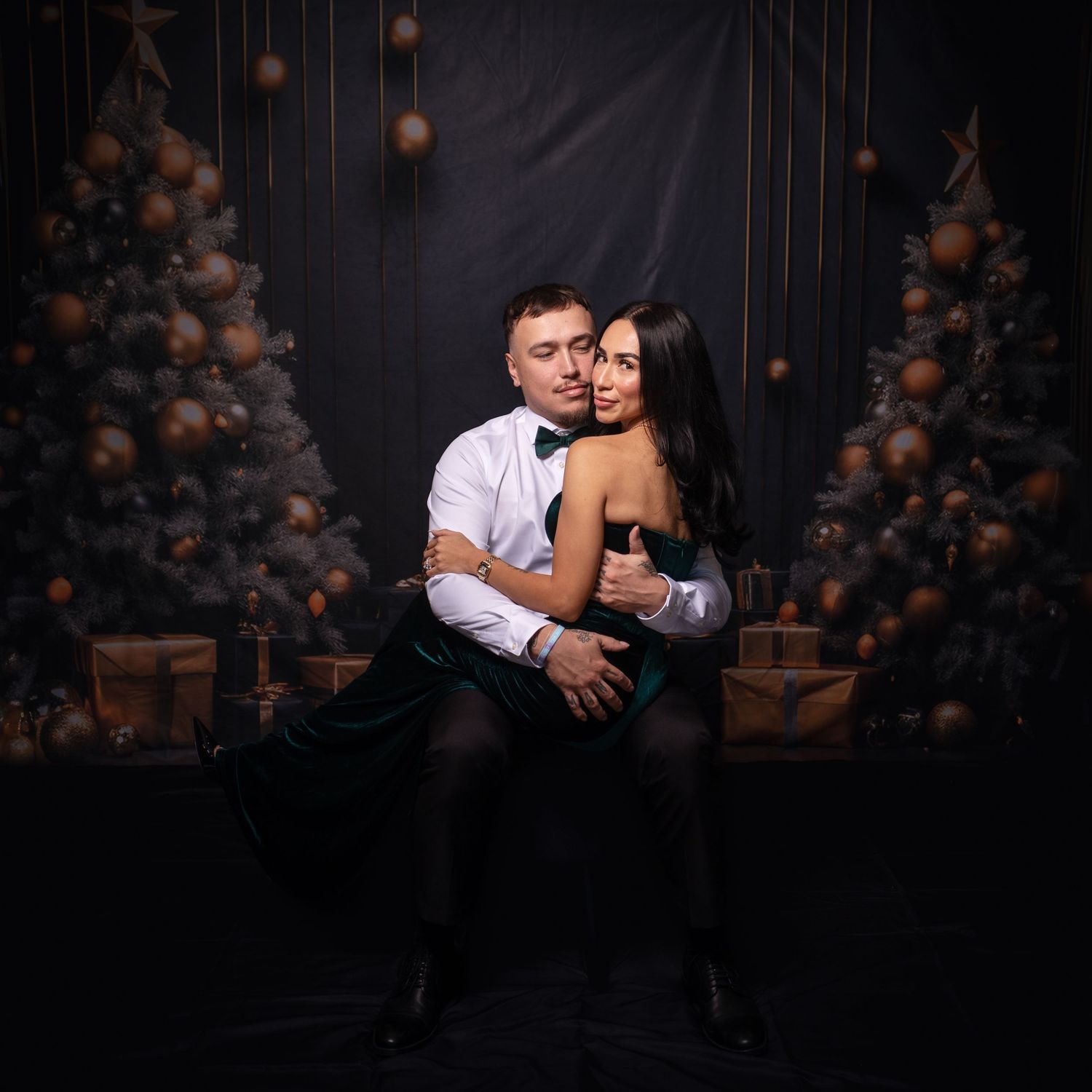 Romantic studio photoshoot featuring couple in elegant attire with balloon decorations.