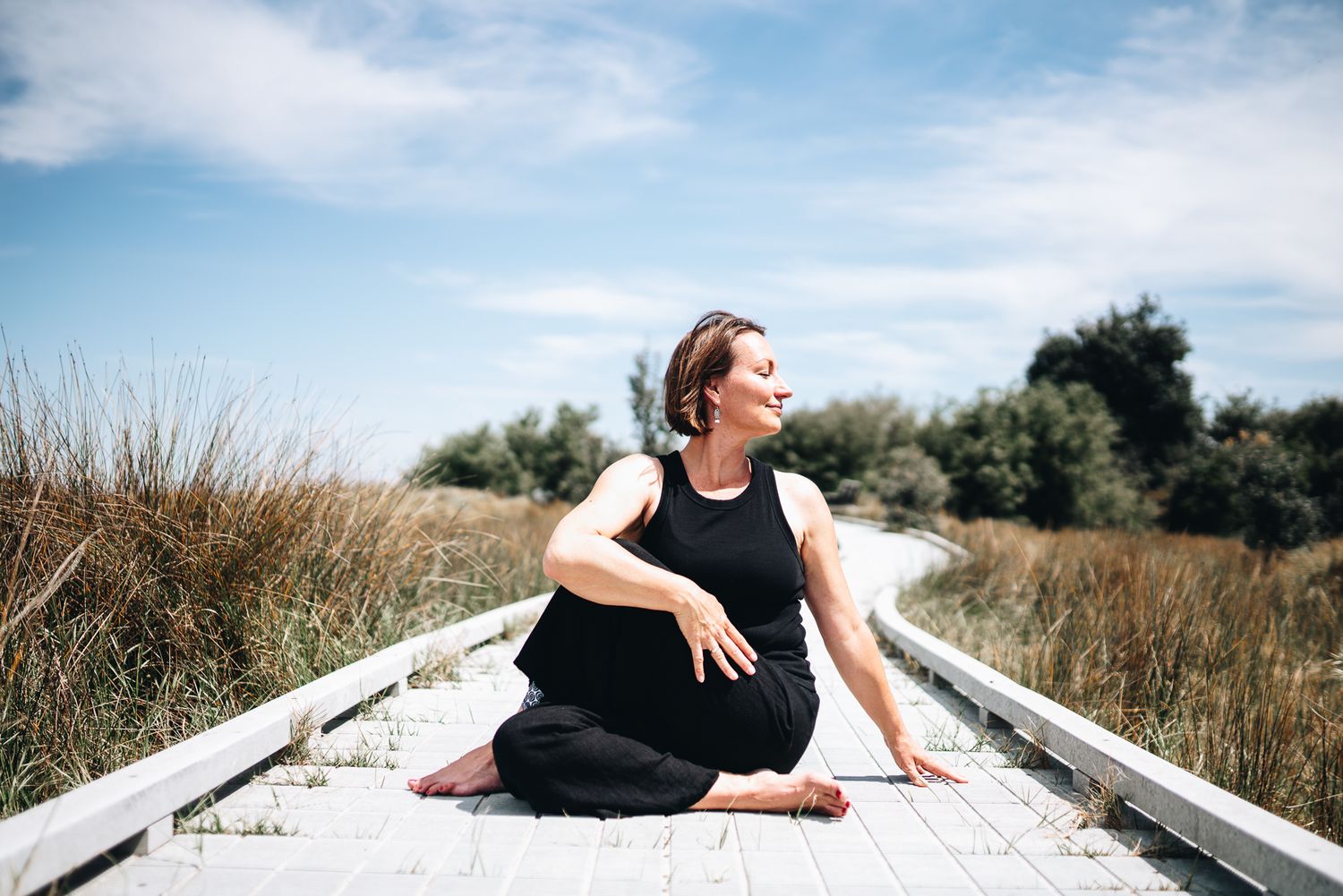 Yoga and qigong instructor doing stretches in an outdoor professional branding photo session with a Melbourne branding Photographer