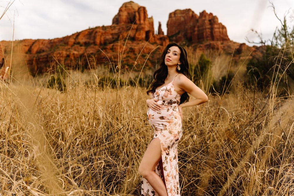 Maternity photography with desert landscape and Sedona red rocks in background.