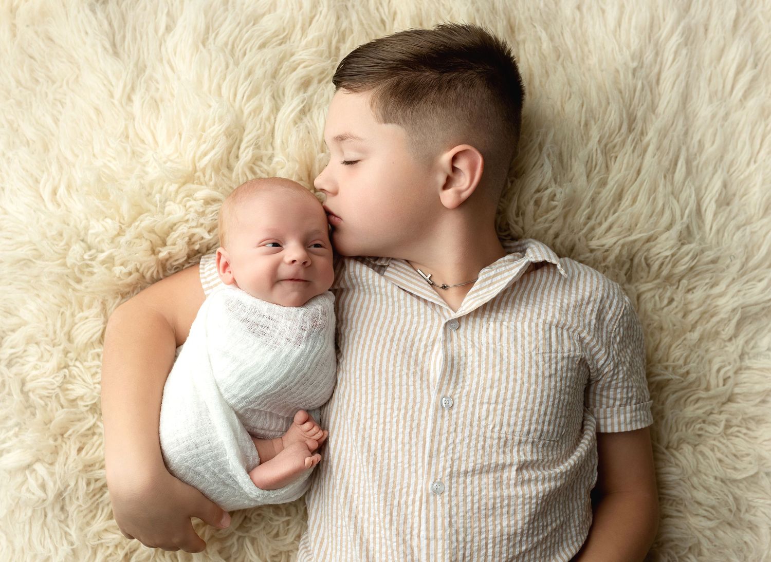 Big brother holding his newborn baby brother. Greenville SC newborn photographer, Easley SC newborn photographer
