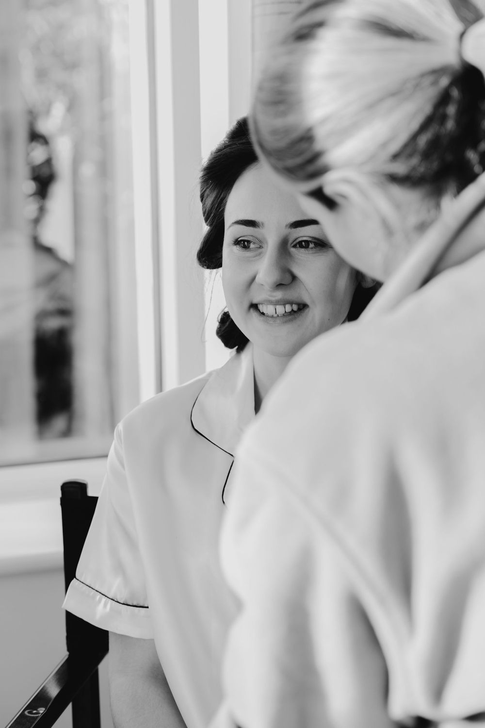 Black and white candid moment of getting ready preparations on a wedding morning.