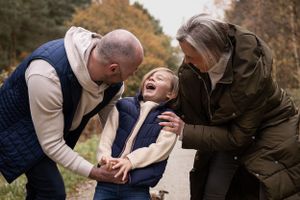 Joyful outdoor moment of shared laughter and connection during an autumn day.
