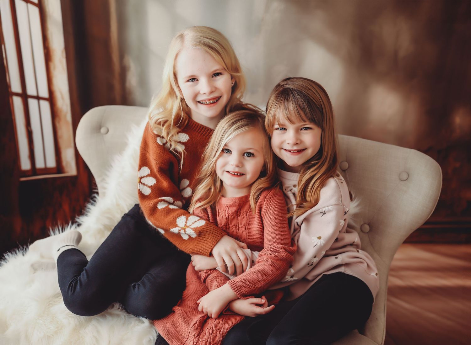 Indoor lifestyle family portrait session on cream colored couch with warm lighting.
Best child's photographer in Illinois