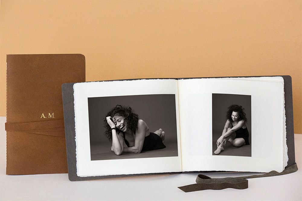 A series of black and white photographs arranged in a horizontal row on a beige wall.