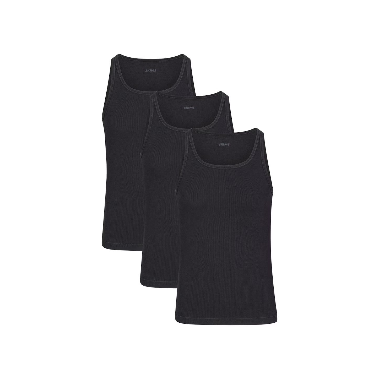 Three black cotton ribbed tank tops arranged in a row showing basic sleeveless undershirts for layering.