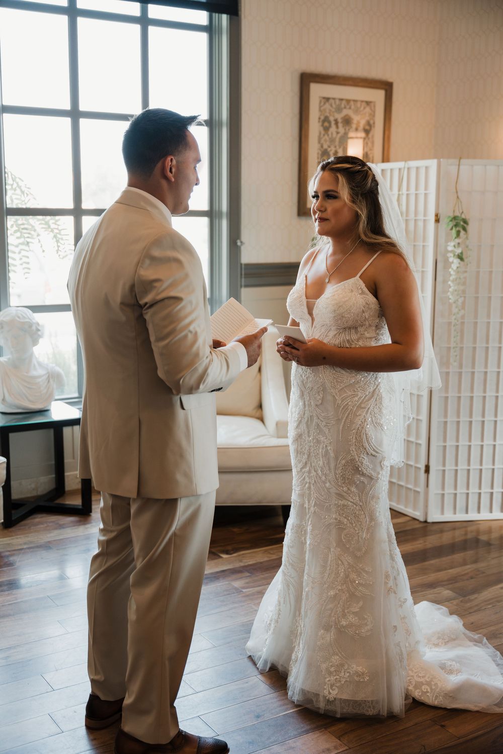A sequence of first look photos showing a couple in wedding attire sharing an emotional moment in a sunlit room.