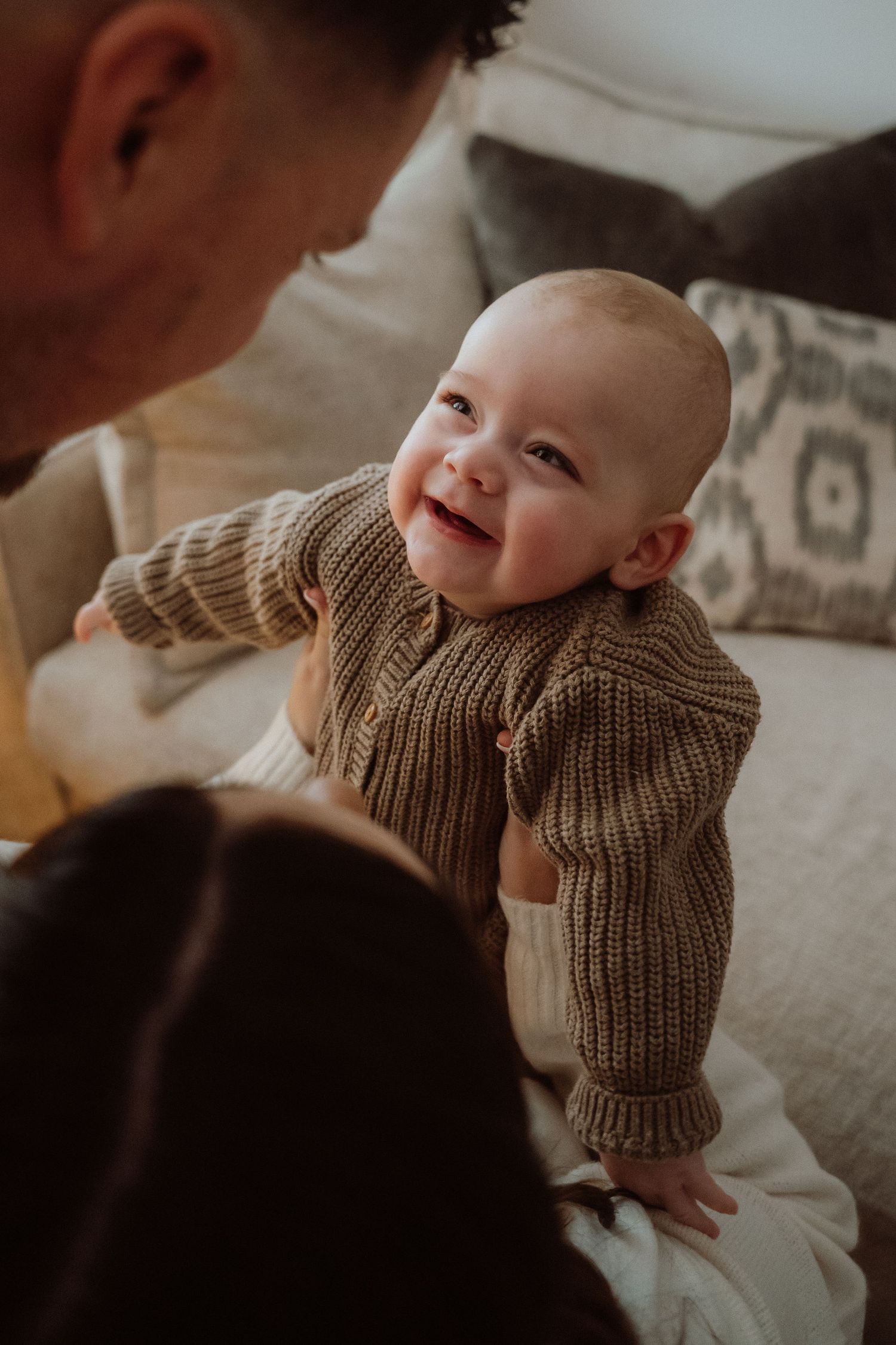 A happy baby in blue and white striped clothing smiles in this close-up photo collage.