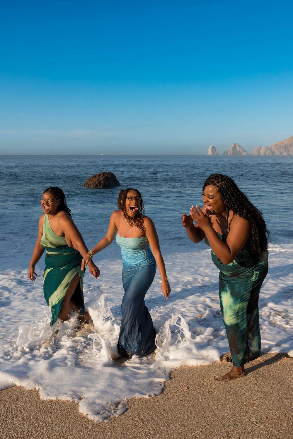 A sequence of images showing friends playing in ocean waves at a beach with rocky cliffs in the background.