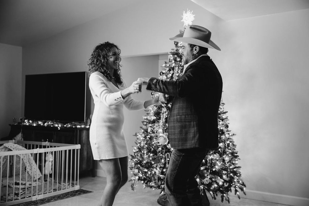 A black and white collage of wedding moments showing dancing, embraces and holiday decorations at an indoor venue.