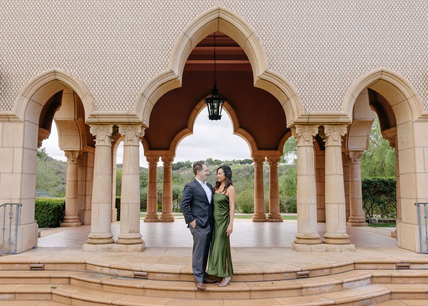 Elegant arched colonnade walkway with stone columns and Mediterranean architectural details.