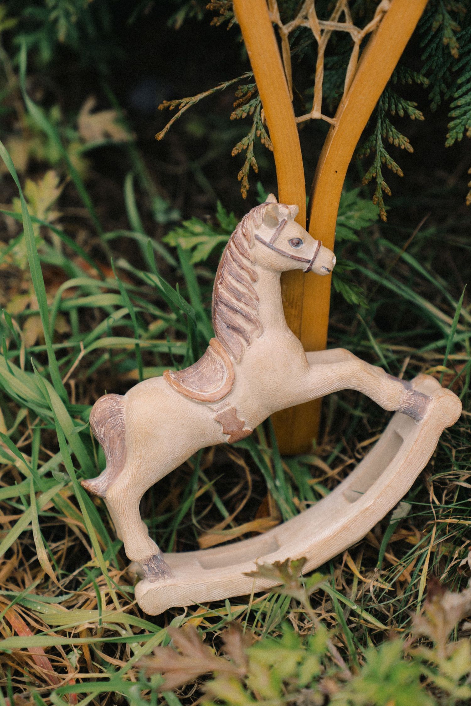 Sequence of clay or ceramic hands reaching upward and grasping bamboo stalks in a garden setting.