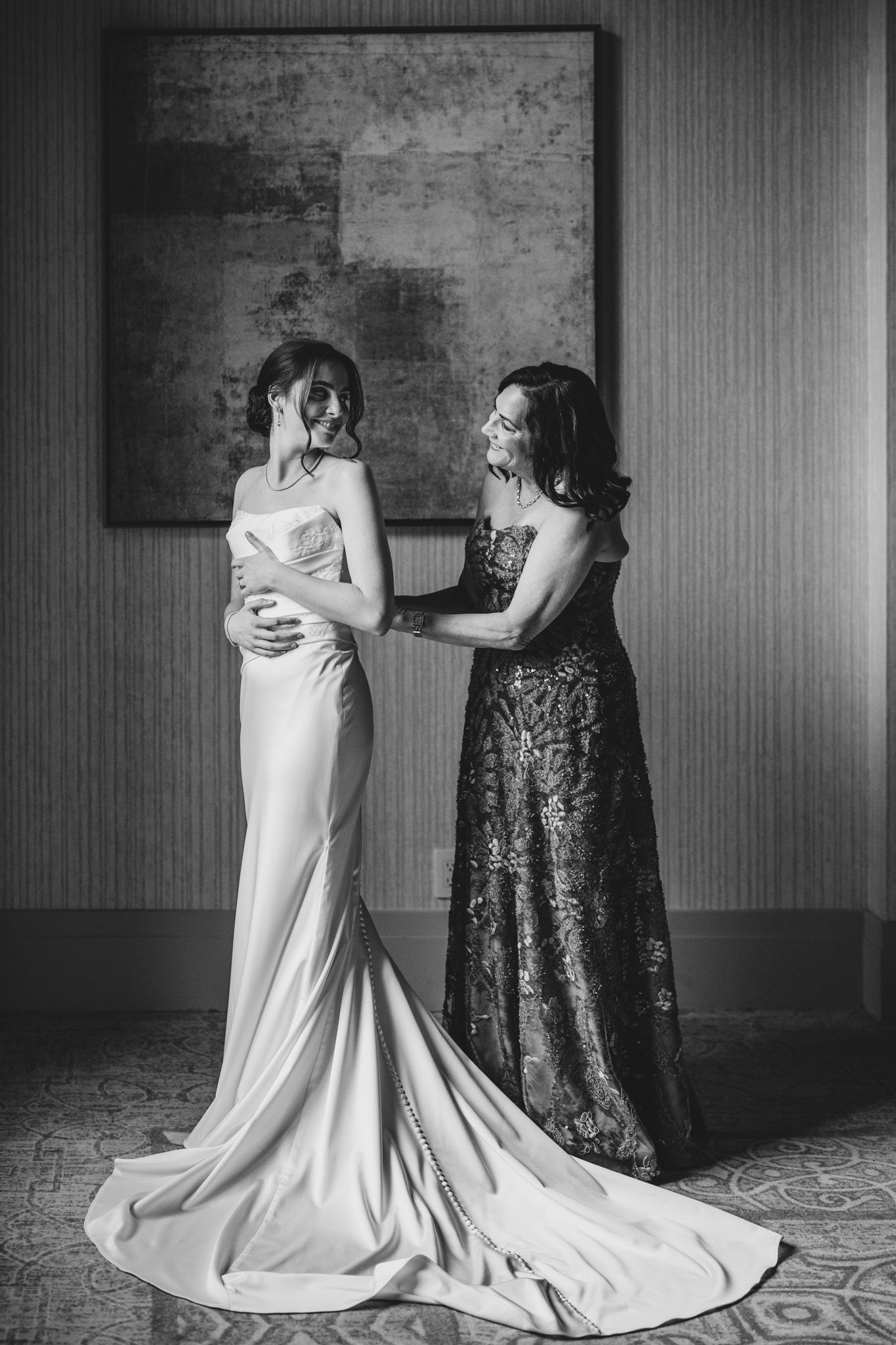 Black and white photos of wedding dress preparations with elegant floor-length gowns.