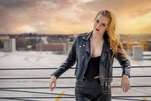 girls posing on top floor of parking garage with epic sunset