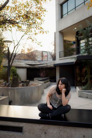 Downtown Boise Senior girl sitting on half wall