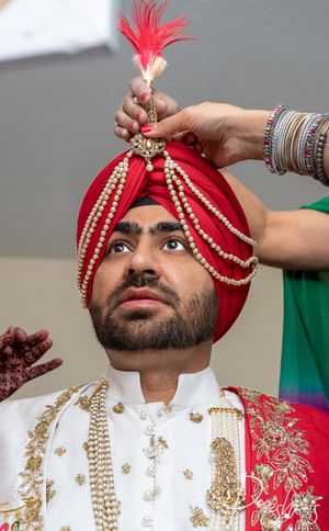 Punjabi wedding very important ritual of wearing a kalgi...