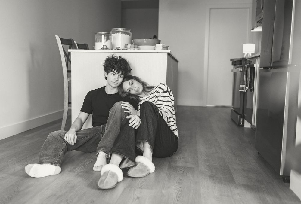 Wide angle black and white shots of a couple's intimate moments in a minimalist interior space.