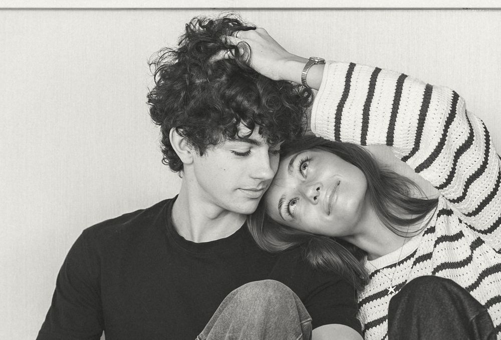 A black and white photo collage showing intimate moments between a couple in striped clothing.