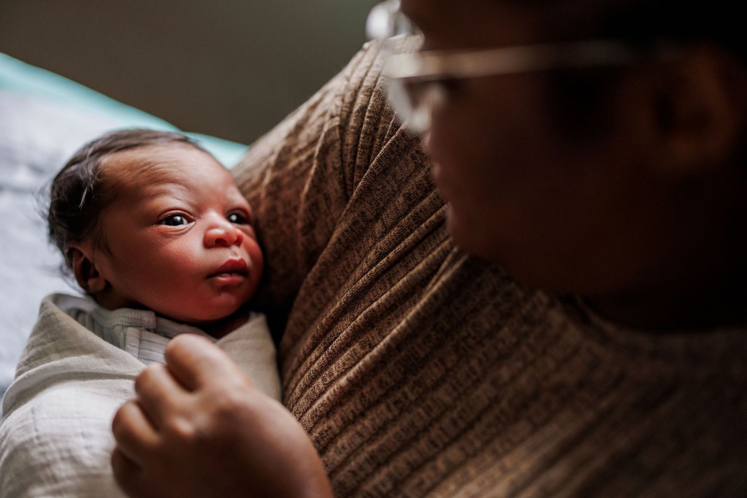 A series of tender newborn baby photography shots showing tiny hands and peaceful sleeping moments in soft lighting.