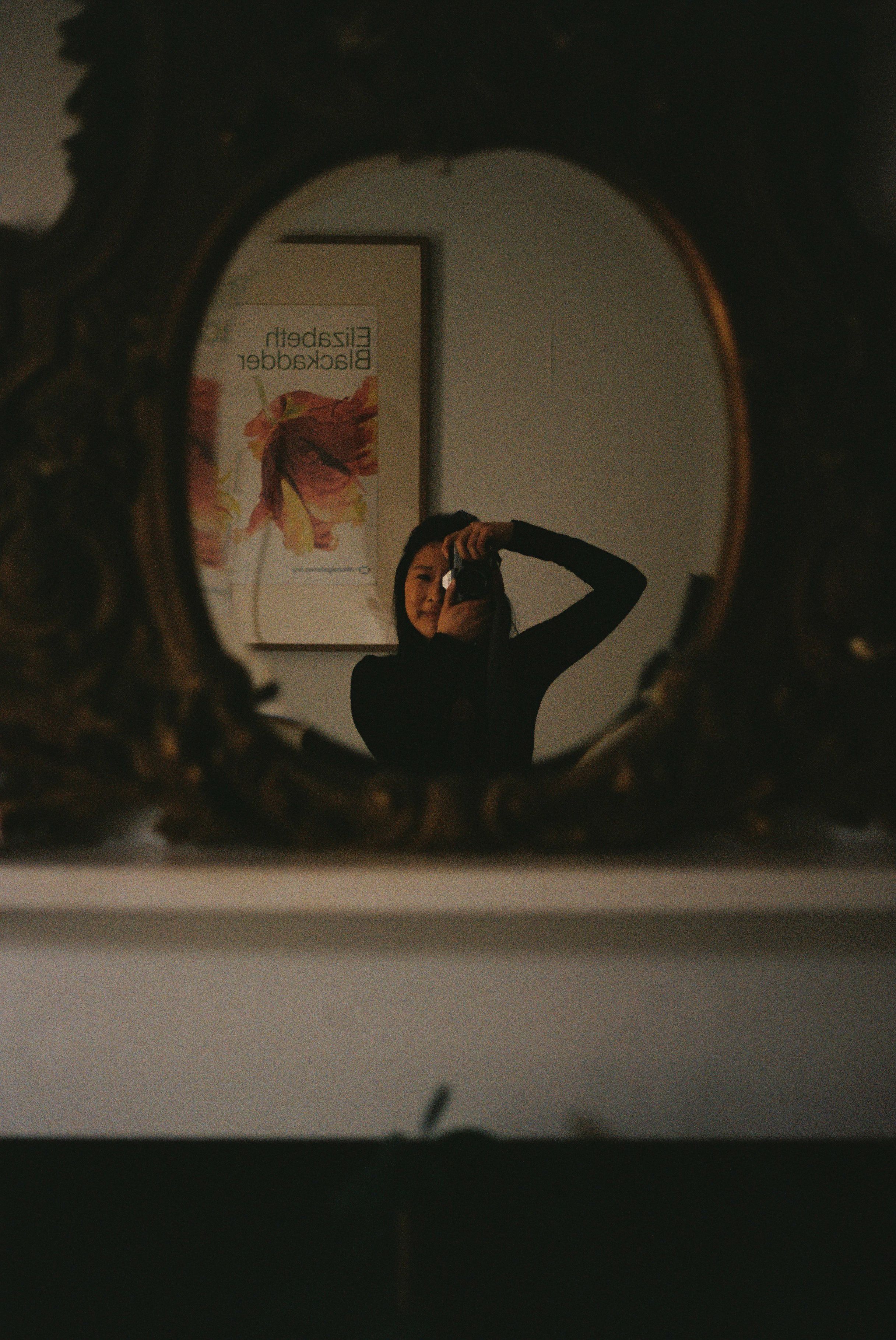 film photograph of the photographer behind lilliioodle photography, captured in a mirror reflection.