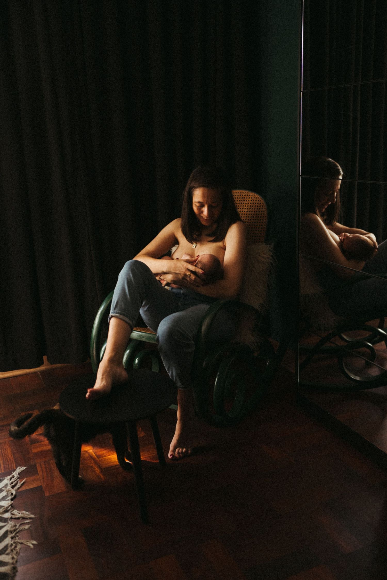 Moody sequence showing silhouettes against dark curtains in warm lighting.