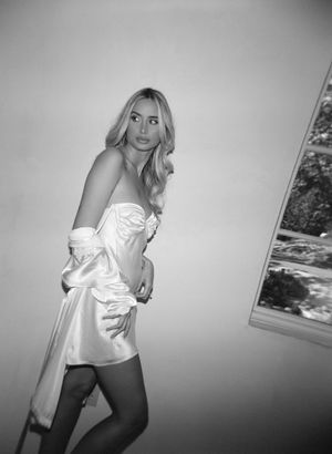 White formal attire against a minimalist background in black and white photography.