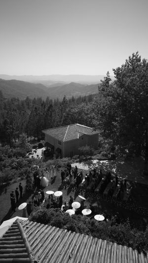 Guests gather on outdoor steps overlooking mountain vistas at an elegant outdoor event venue.
