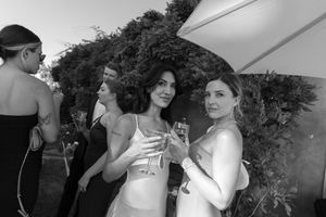 Wedding guests enjoying cocktail hour on an outdoor patio.