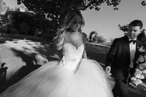 Black and white wedding photography in natural outdoor setting.