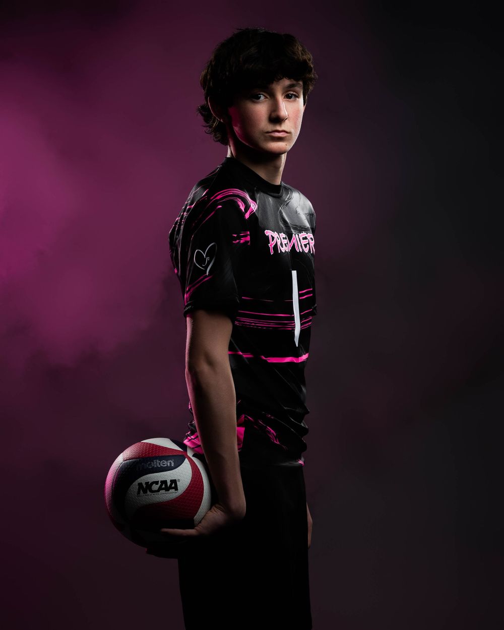 Dramatic sports portrait series of volleyball player in black uniform against purple backdrop with dramatic lighting.
