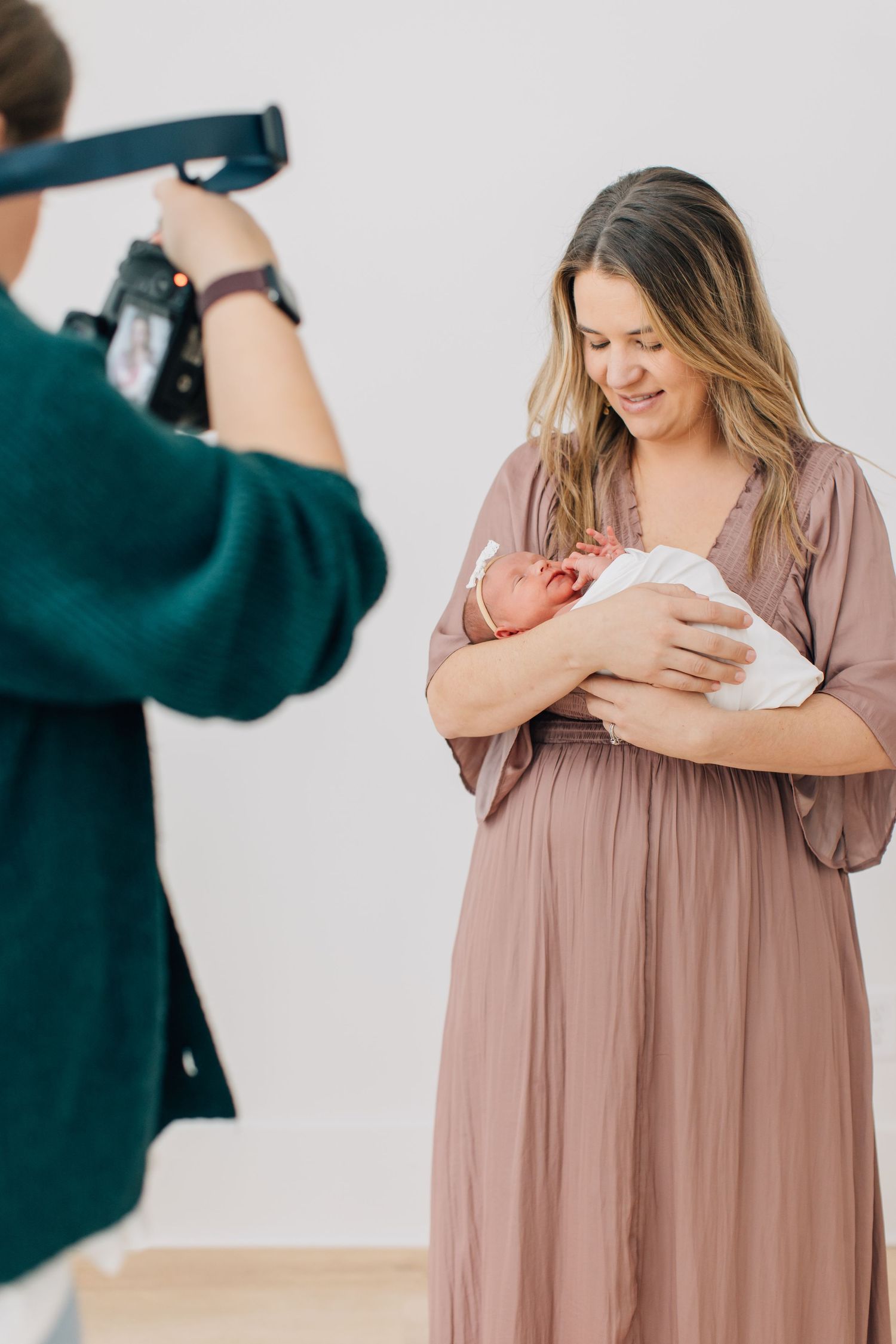Lifestyle photography session showing intimate moments with newborn baby in soft natural light.