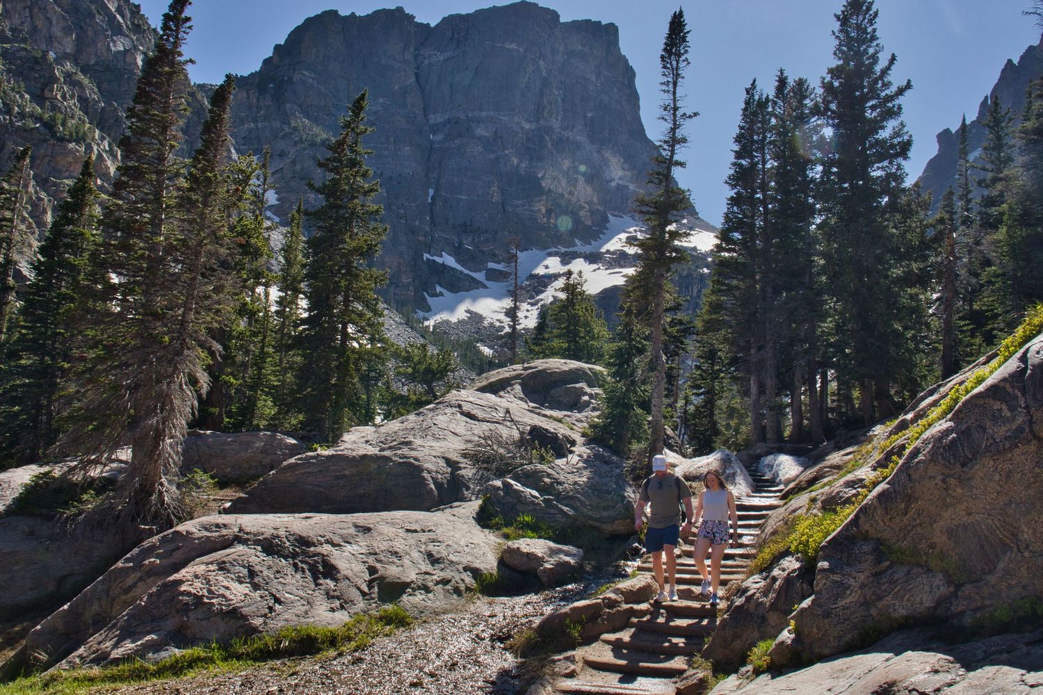 Couple hiking down from Emerald Lake in RMNP after he proposed to her. She said YES! Pixcapades | The Rocky Mountain Proposal Photographer