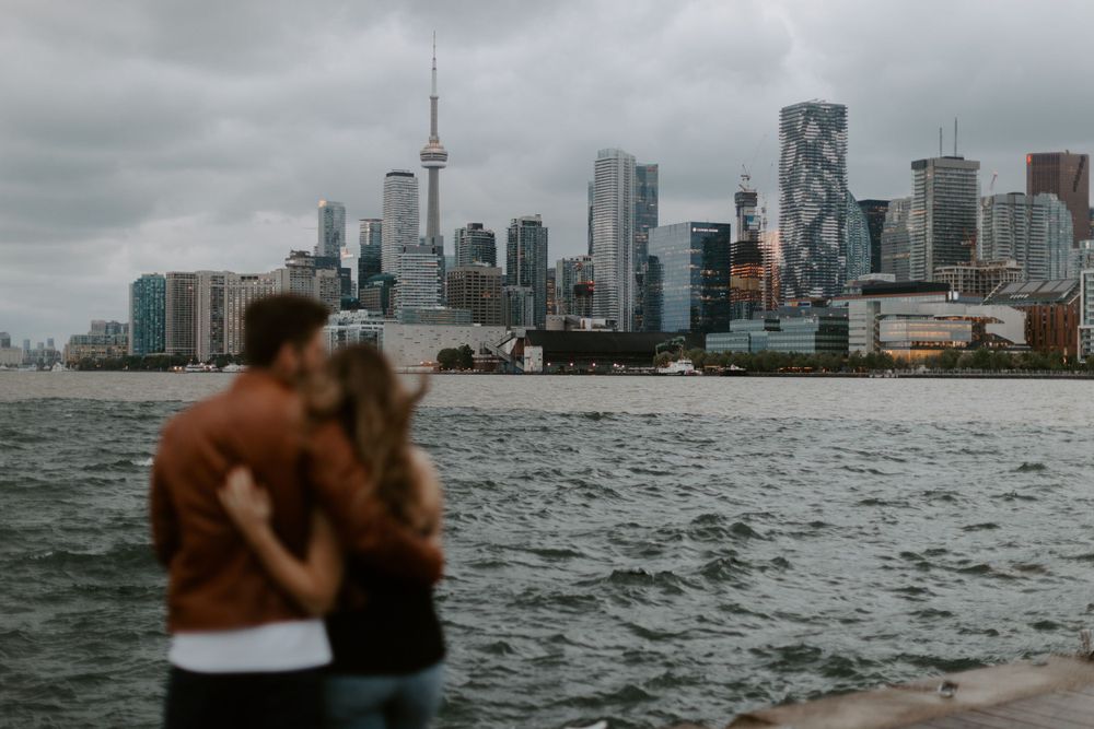 distillery and polson pier engagement photography session in downtown toronto, with the CN tower skyline