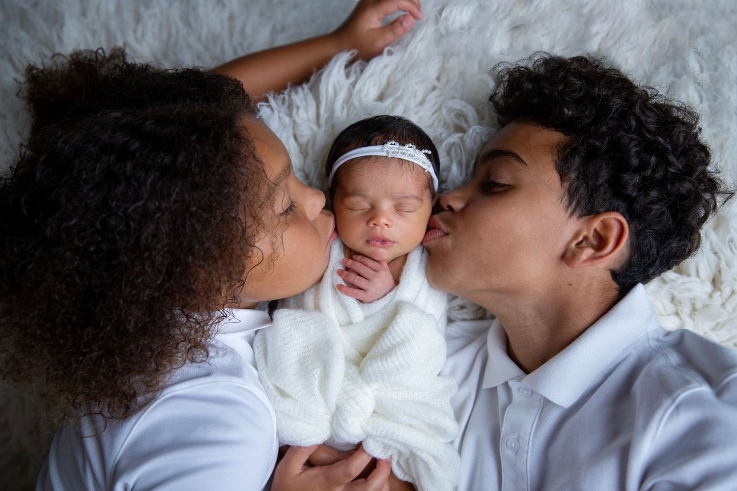 Newborn baby with siblings during newborn photography session in Orange City Florida