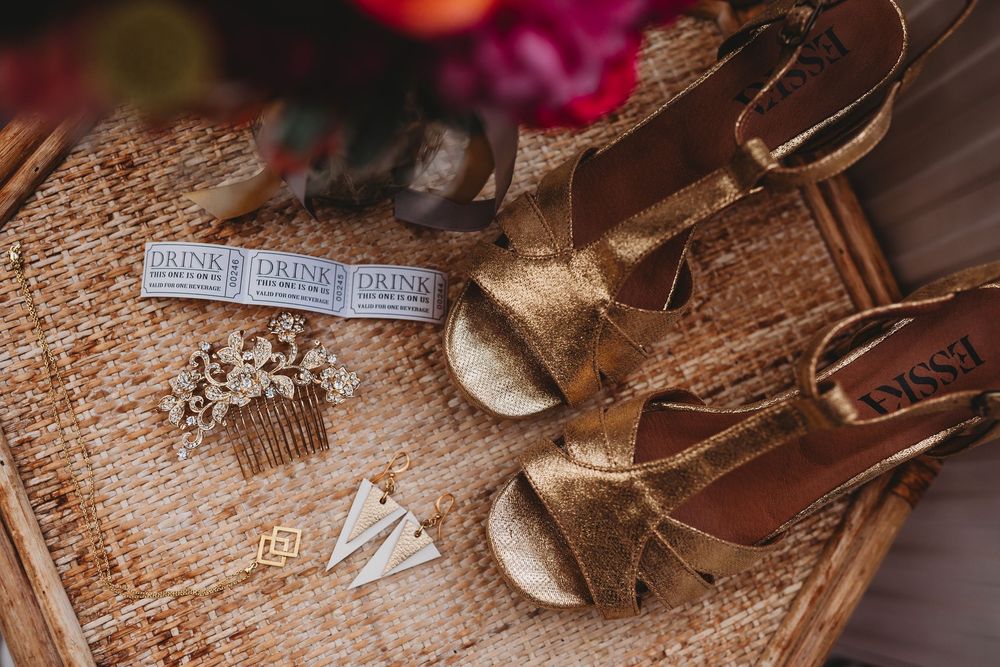 Wedding detail shots of vintage accessories and decorative items on textured surface.