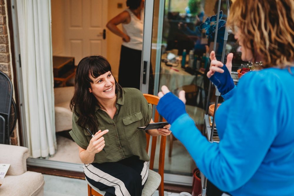 Candid conversation sequence between two people sitting in a living room setting.