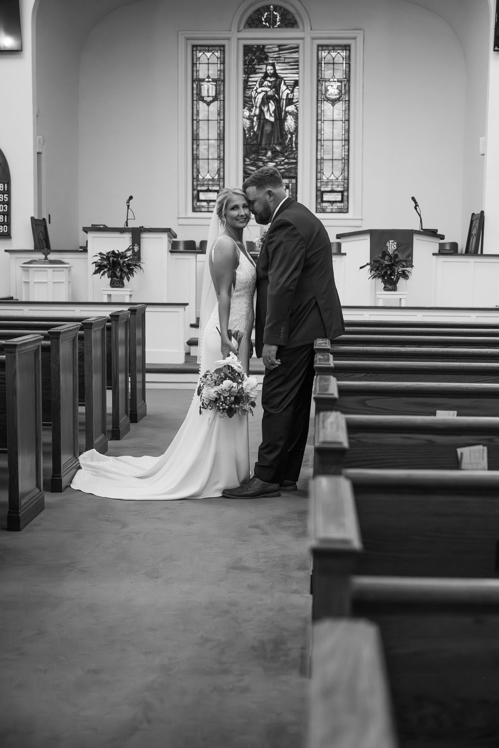 Black and white photos in a traditional church sanctuary with stained glass windows and wooden pews.