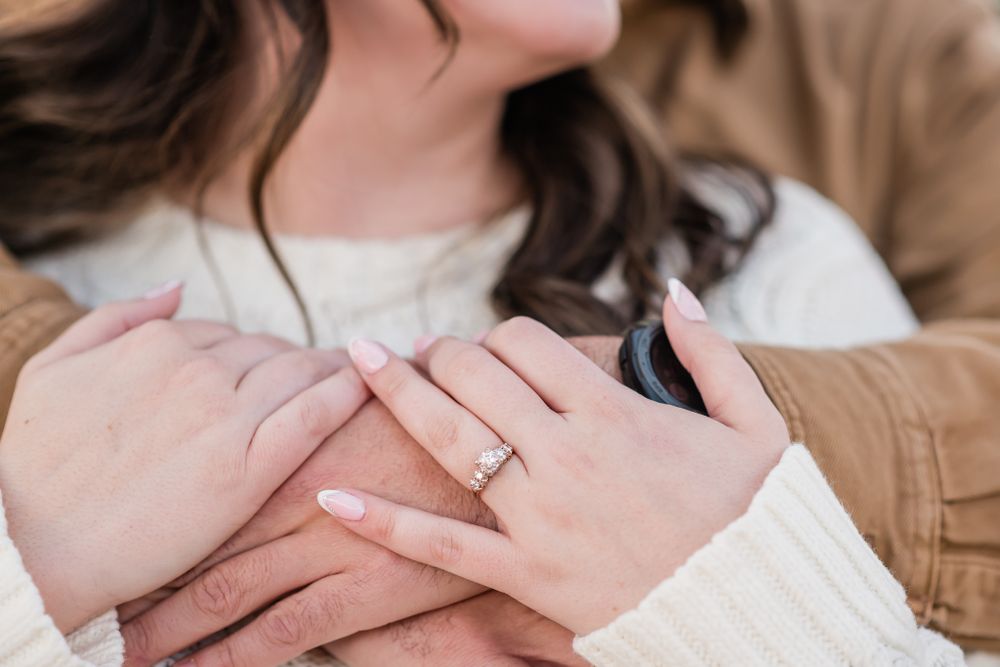 Close-up shot of hands with engagement ring showcasing a romantic moment.