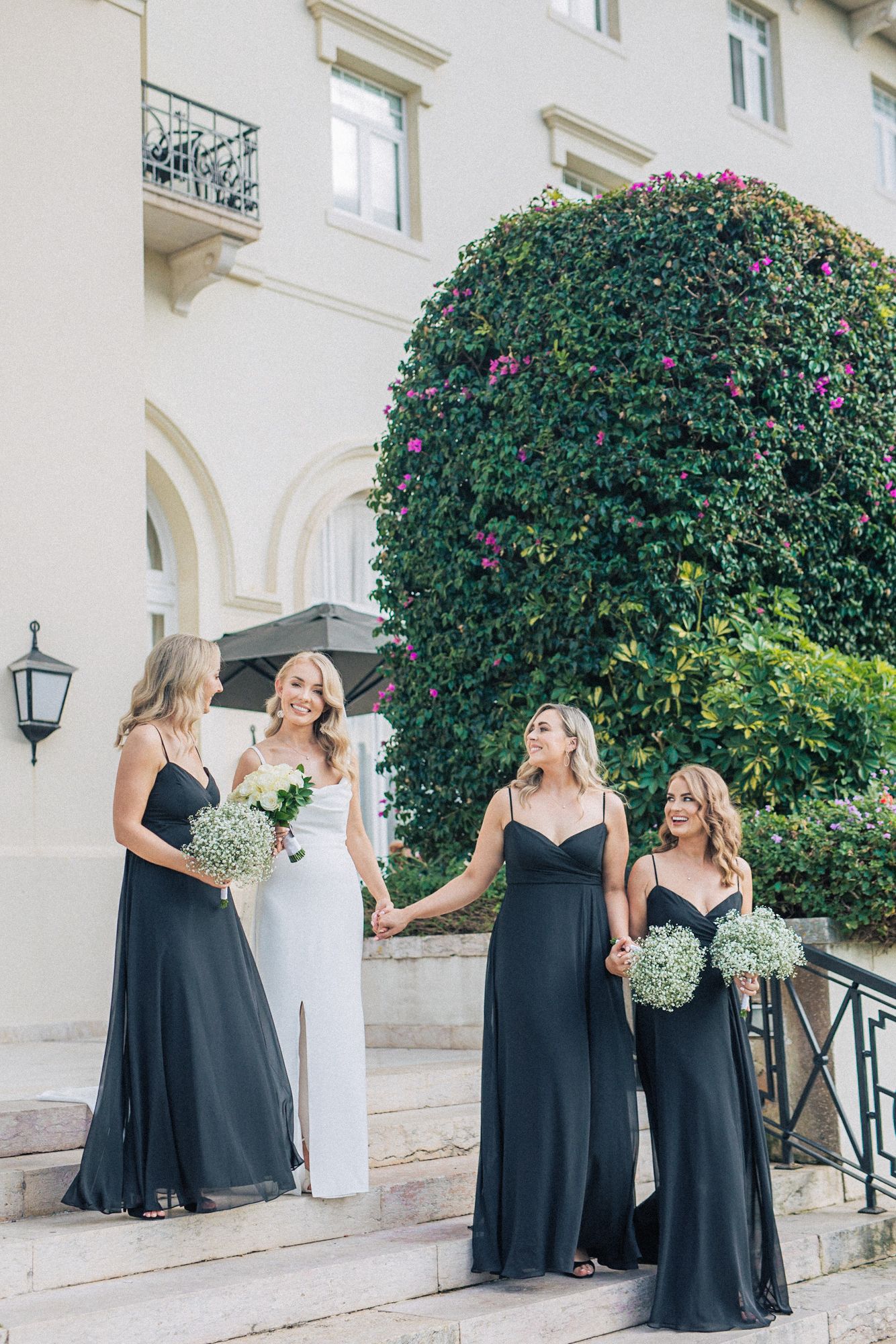 Bridal party with bridesmaids wearing black dresses at hotel palacio, Estoril. captured by a destination wedding photographer in portugal