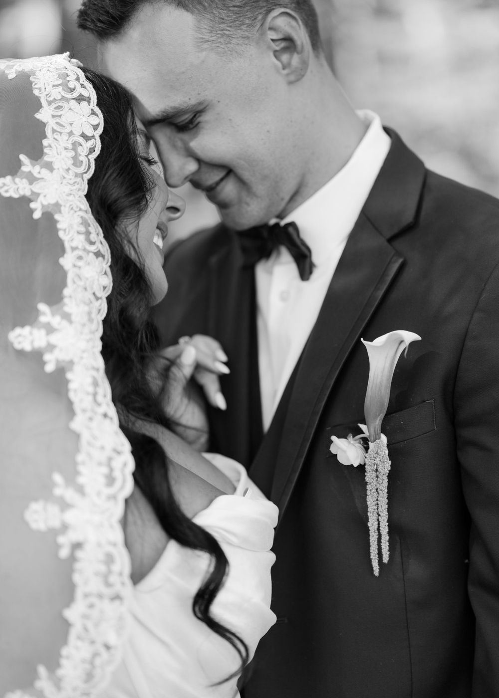 Black and white romantic portraits of a couple in formal wedding attire.