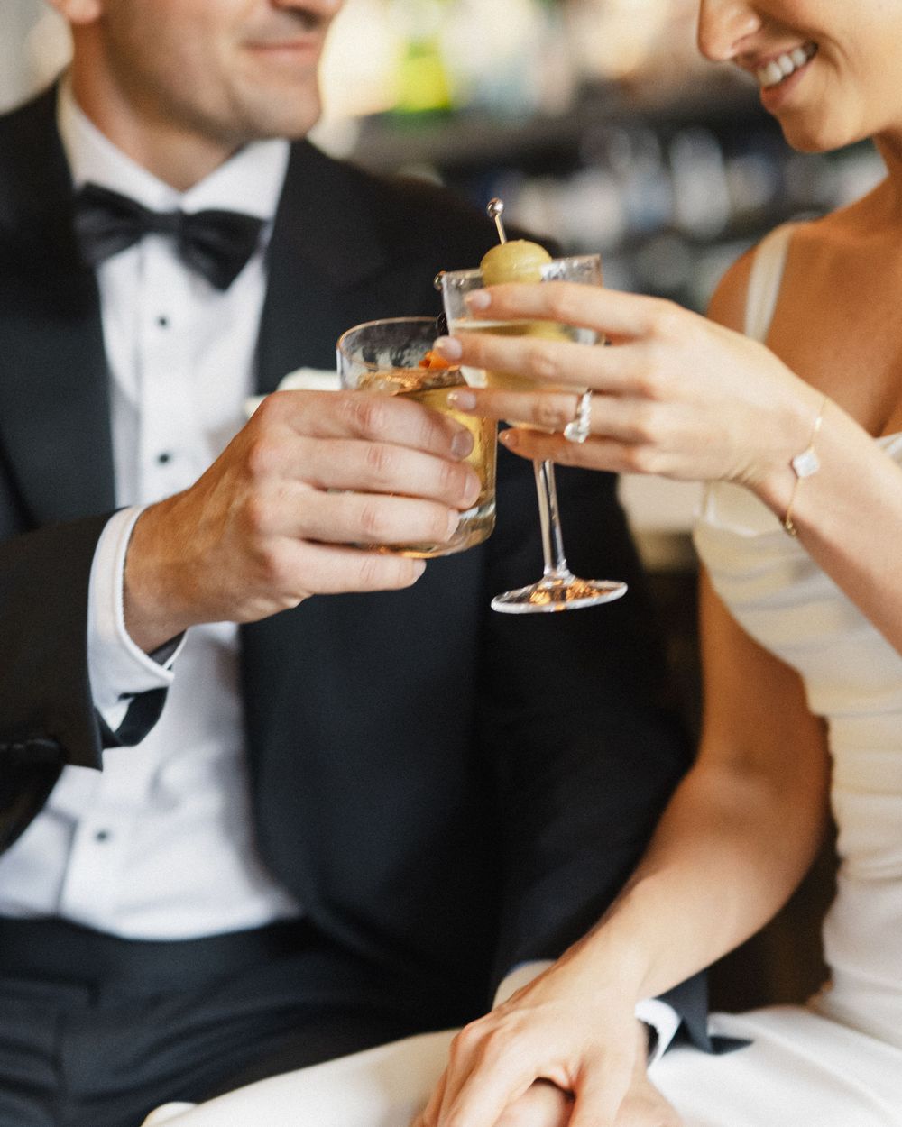 Wedding guests in formal attire toast with champagne glasses during a celebration.