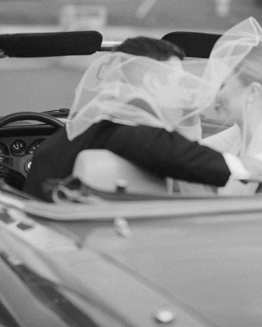 Close-up detail of white fabric draping across a surface in soft focus.