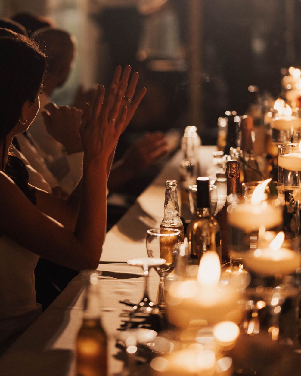Candlelit table settings create an intimate ambiance at an evening reception.