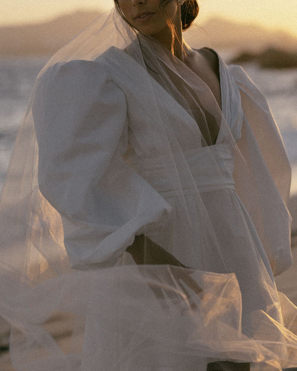 Ethereal motion blur captures a figure in white clothing against a soft background.