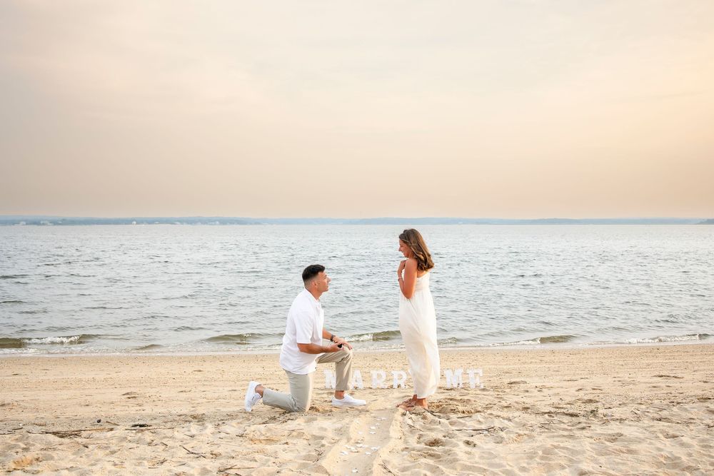 A series of people in white outfits walking along a serene beach at sunset with soft golden lighting.