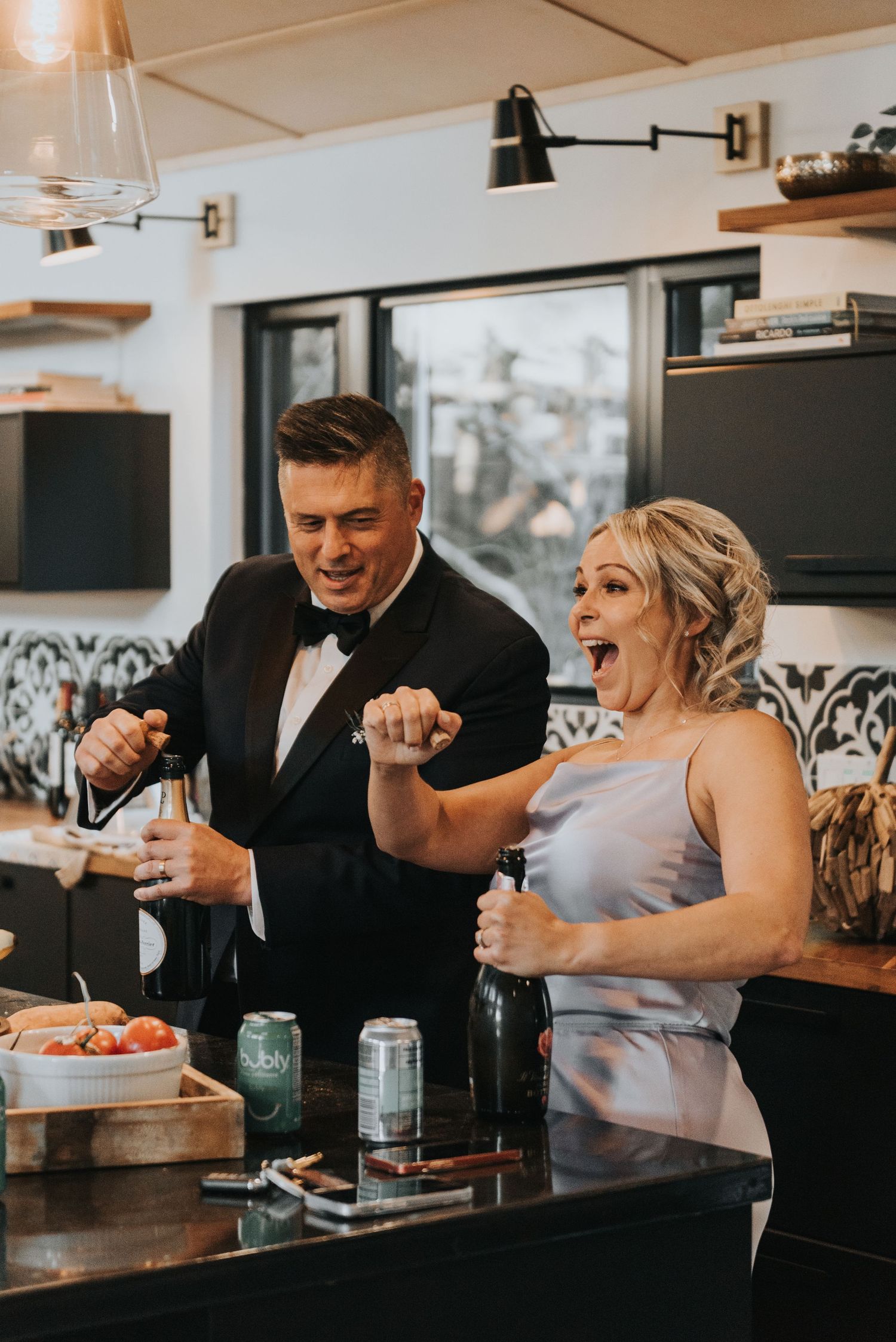 Celebratory moment at an elegant party with attendees in formal attire enjoying drinks together.