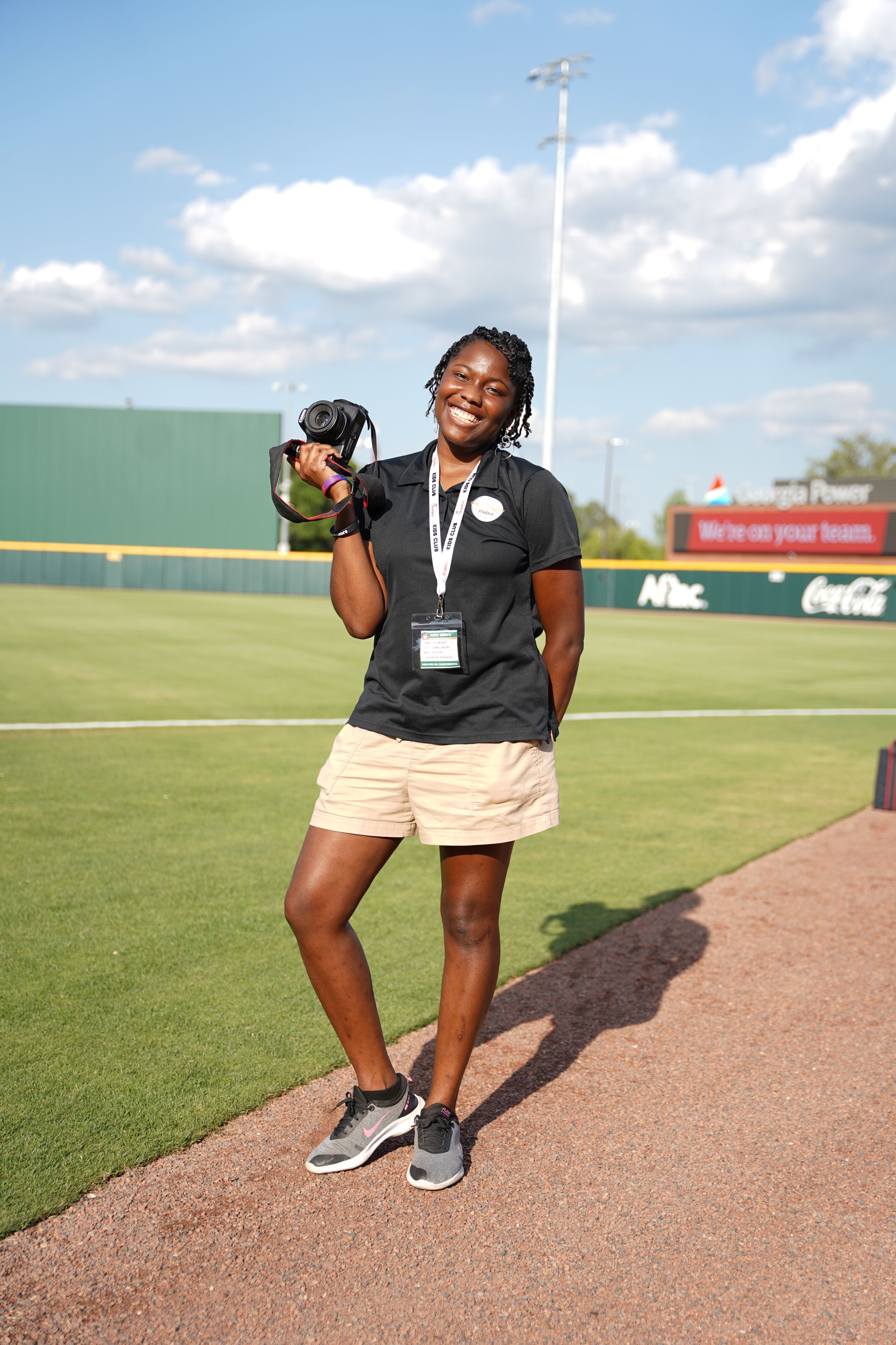 Row of photographers with professional cameras photographing during sports or media event.