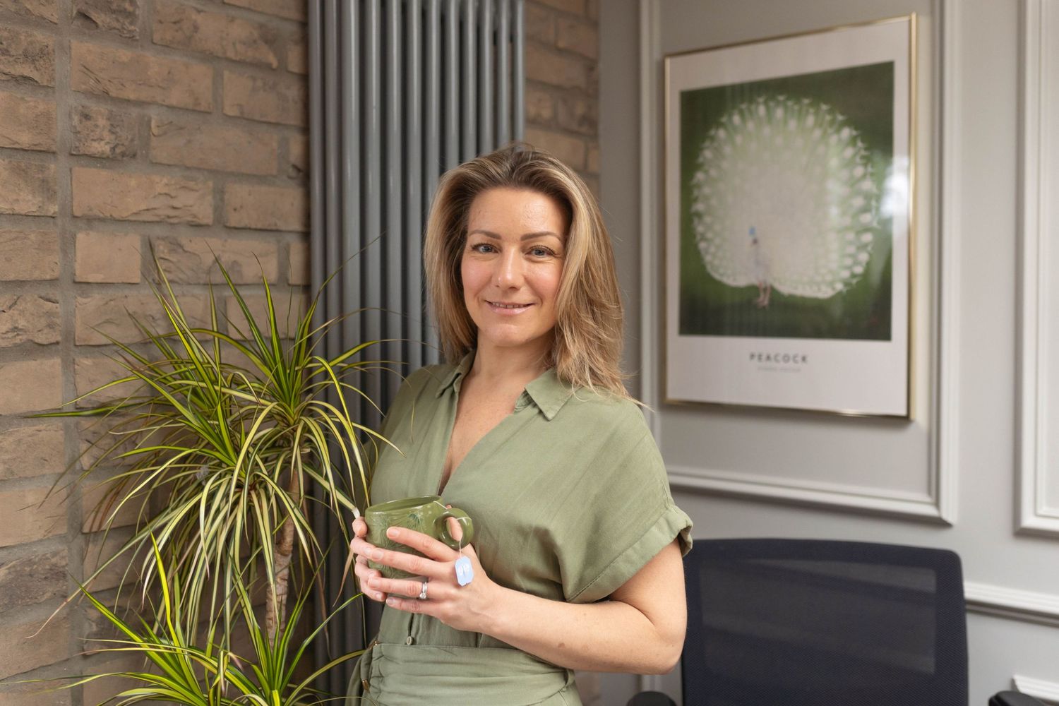 portrait of woman holding a cup of tea in photoshoot