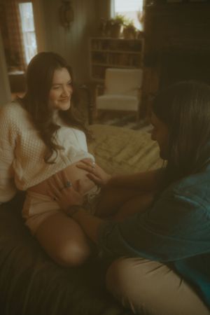Candid moment shared between two people sitting together in a warmly lit room with vintage aesthetic.